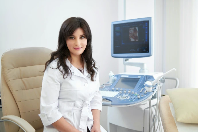 A woman sitting in front of an ultrasound machine