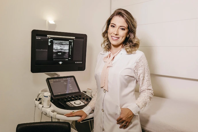 A woman sitting in front of an ultrasound machine